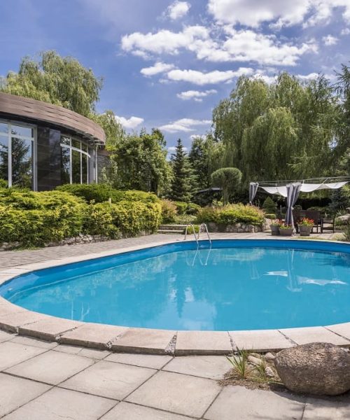 oval-swimming-pool-in-big-garden-2021-08-26-15-44-17-utc-min